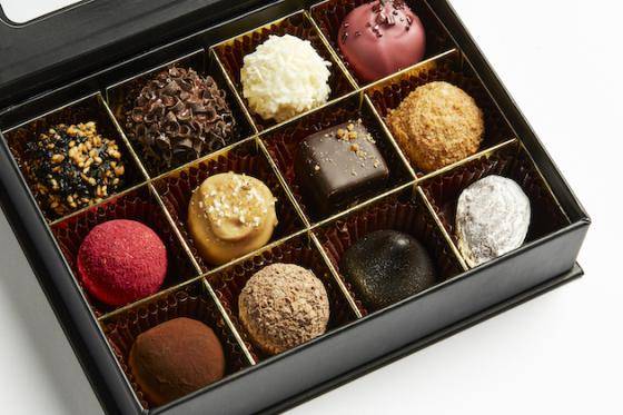An open box displaying a varied assortment of chocolate confections
